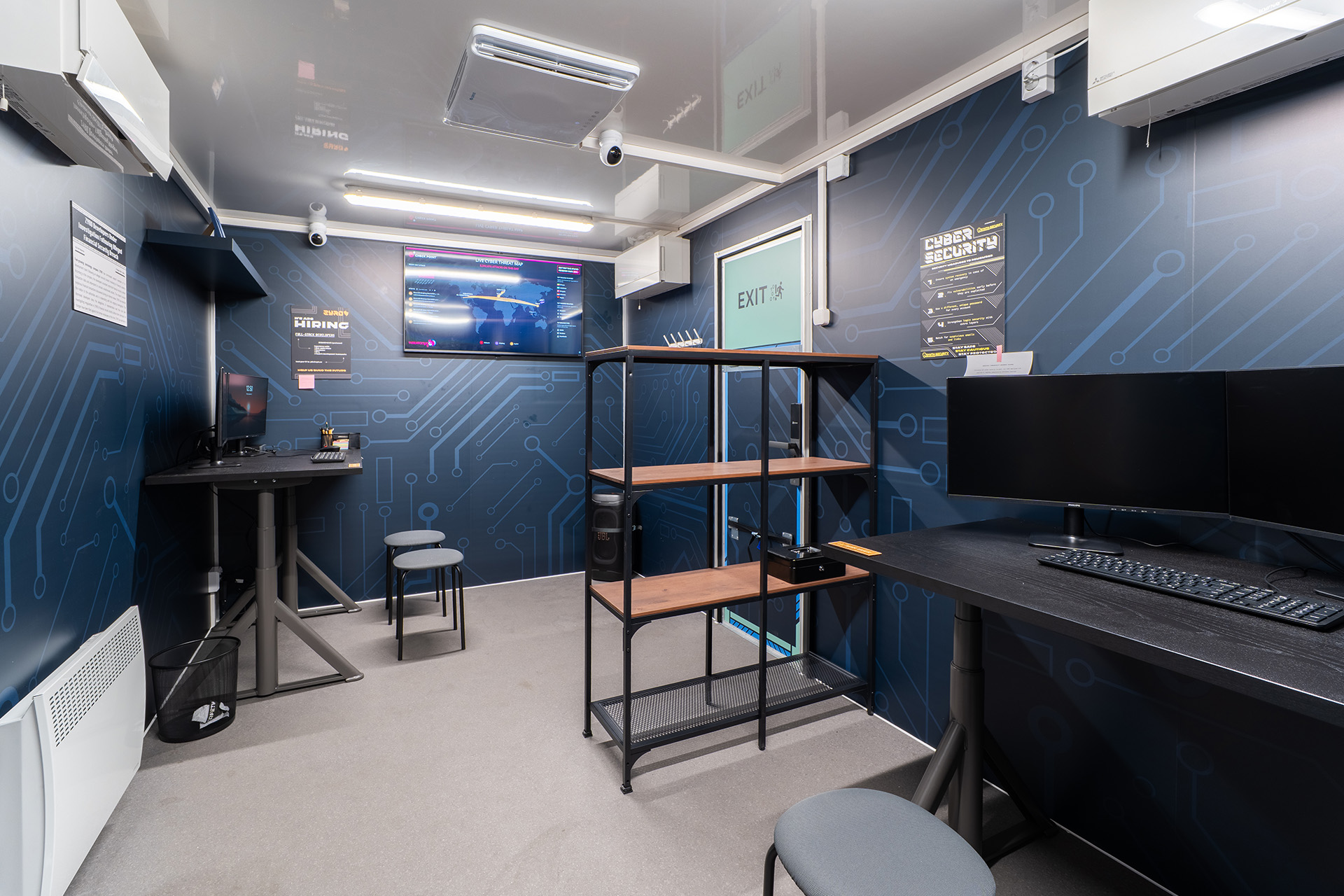 Interior of the escape room with desks and screens